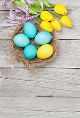 Easter greeting card with eggs and tulips