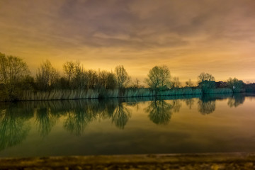 Fototapeta na wymiar River night colors yelloy sky reflection
