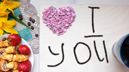 strawberry, cookie hearts with a Cup of black coffee beans, with yellow flowers and a note I LOVE you happy Valentine's day mother
