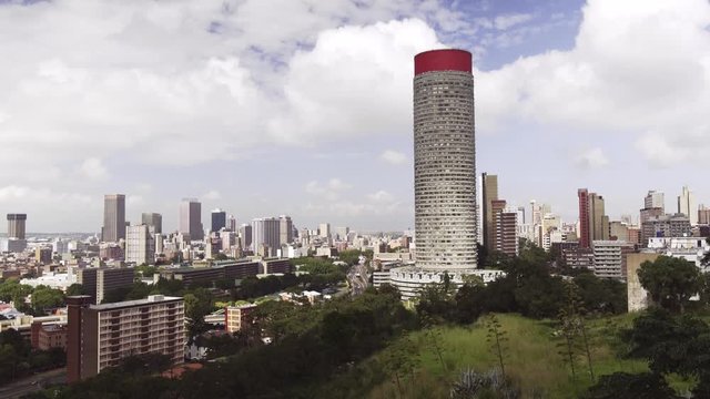 The Ponte Tower or Ponte City Apartments in Johannesburg South Africa shot from a hill. High angle static. Full shot.