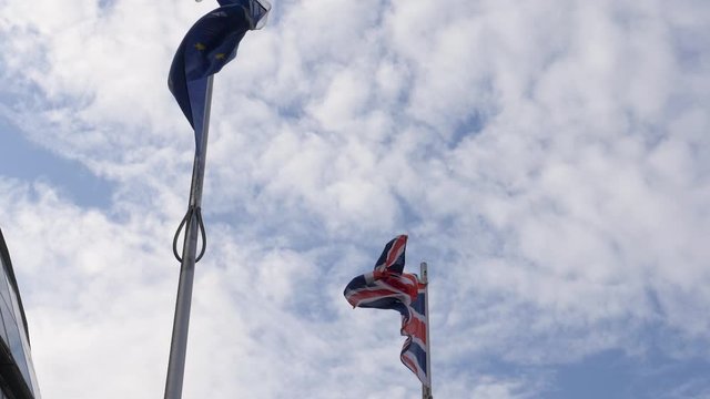 Union Jack and the EU flag next to each other in Slow Motion