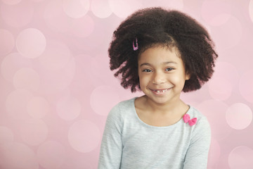Obraz premium Happy adorable african american child girl isolated on light background. Laughing face. Real emotions.