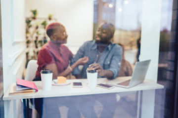 Partners talking in cafe during distance work
