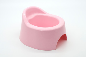 Pink baby potty on a white background. Side view