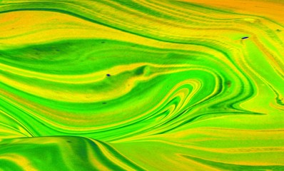 Green and yellow marble abstract background. Natural stone texture. Acrylic paint flows freely and...