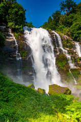 Fototapeta na wymiar Wachirathan Waterfall at Doi Inthanon National Park, Mae Chaem District, Chiang Mai Province, Thailand. Fresh flowing water in tropical rainforest. Green trees, vibrant colors, tranquility
