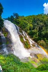 Wachirathan Waterfall at Doi Inthanon National Park, Mae Chaem District, Chiang Mai Province, Thailand. Fresh flowing water in tropical rainforest. Green trees, vibrant colors, tranquility