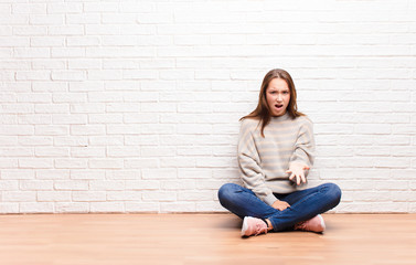 young blonde pretty girl looking angry, annoyed and frustrated screaming wtf or what‚Äôs wrong...