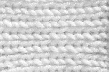 Handmade knitting texture, white background. Gray wool with fine threads, close-up.