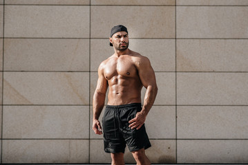 Sexy man posing topless in the hot sun. Fitness. Lifestyle