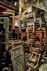 Garage sale of ancient wooden Chinese style furniture.