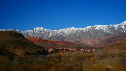 Bright landscape of Morocco, breathtaking curves of mountains, stunning combination of hills & farm land,inadvertent distribution of houses & huts, raw impression of pure nature.