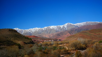 Bright landscape of Morocco, breathtaking curves of mountains, stunning combination of hills & farm land,inadvertent distribution of houses & huts, raw impression of pure nature.