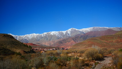 Obraz premium Bright landscape of Morocco, breathtaking curves of mountains, stunning combination of hills & farm land,inadvertent distribution of houses & huts, raw impression of pure nature.