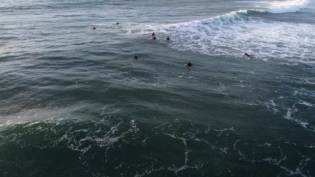 Surfers in Ribeira de Ilhas beach in Ericeira Portugal