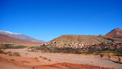 Bright landscape of Morocco, breathtaking curves of mountains, stunning combination of hills & farm land,inadvertent distribution of houses & huts, raw impression of pure nature.