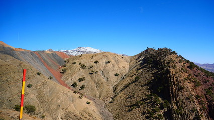 Bright landscape of Morocco, breathtaking curves of mountains, stunning combination of hills & farm land,inadvertent distribution of houses & huts, raw impression of pure nature.
