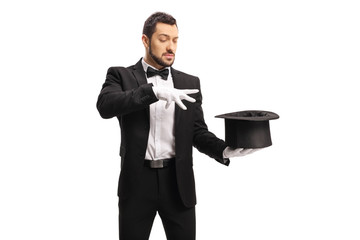 Male magician performing a trick with hands and a top hat