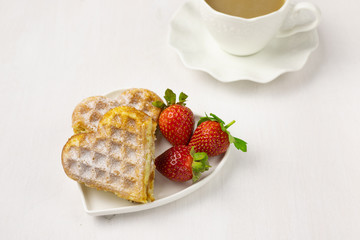Waffle biscuits in shape of heart on rustic background for Valentines day