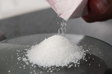 Pouring Sugar on Kitchen Scale