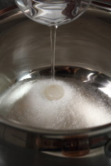 Add water into pan with sugar. Making Golden Syrup Series.