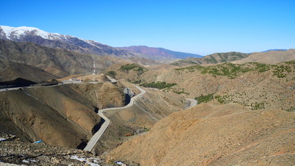 Bright landscape of Morocco, breathtaking curves of mountains, stunning combination of hills & farm land,inadvertent distribution of houses & huts, raw impression of pure nature.
