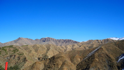 Bright landscape of Morocco, breathtaking curves of mountains, stunning combination of hills & farm land,inadvertent distribution of houses & huts, raw impression of pure nature.