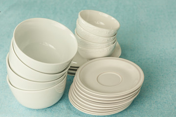 stack of empty white plates bowls 