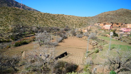 Bright landscape of Morocco, breathtaking curves of mountains, stunning combination of hills & farm land,inadvertent distribution of houses & huts, raw impression of pure nature.