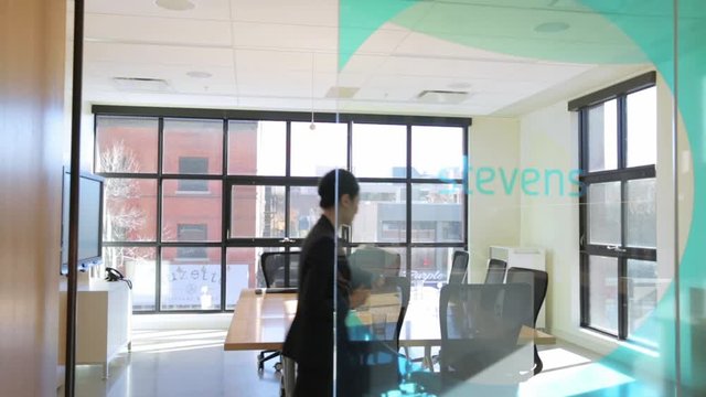 Businesswoman arriving in conference room and placing folders on table