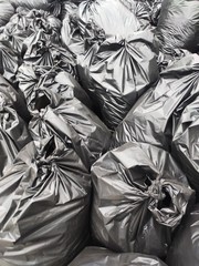 Fototapeta na wymiar black garbage bags piled together. background of plastic black bags