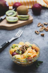 Healthy fruits salad - mango, citrus, kiwi fruit, plum and persimmon. clean eating.