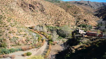 Bright landscape of Morocco, breathtaking curves of mountains, stunning combination of hills & farm land,inadvertent distribution of houses & huts, raw impression of pure nature.