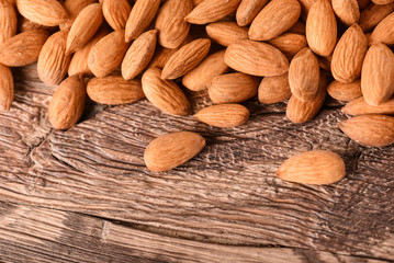 Almond nuts on wooden table top view. Fresh almonds copy space.