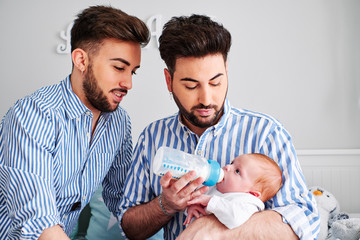 a gay couple with their son - gay parents concept