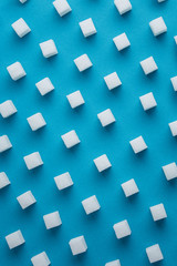 Fototapeta na wymiar Sugar refined pattern on a blue background.