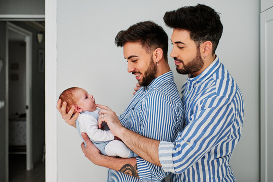 a gay couple with their son - gay parents concept