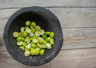 split lemons for tacos in molcajete of Mexican type mud