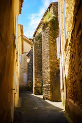 Vertical picture of scenic stone medieval narrow street in Lourmarin, one of the most beautiful villages of France located in Luberon, heart of Provence. Famous popular tourist destination.