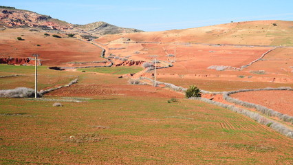 Obraz premium Bright landscape of Morocco, breathtaking curves of mountains, stunning combination of hills & farm land,inadvertent distribution of houses & huts, raw impression of pure nature.