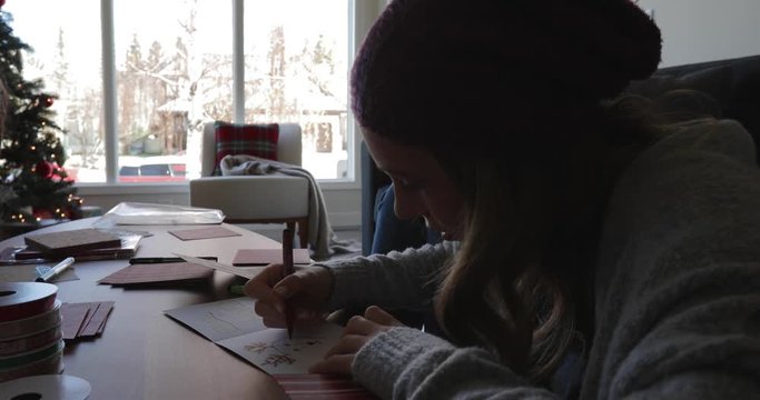 Girl making Christmas cards