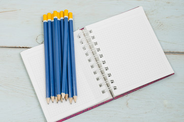 graphite pencils on page of notebook