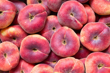 Fig peach or flat peaches. delicious juicy ripe saturn peaches background. Harvest of fresh tasty...