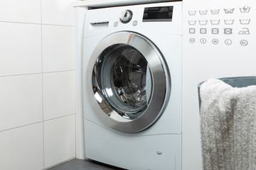 Cleaning and loading white washing machine 