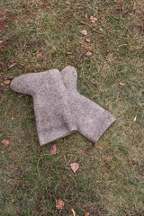 Felt boots on the grass. Symbol of winter without snow in Russia.