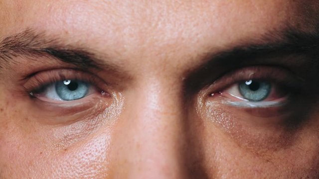 Close-up eyes of a handsome man after the procedure for laminating eyelashes in a beauty salon. Modern eyelash healing. Professional procedure for lamination and Botox eyelashes for men