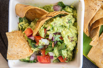  Mexican guacamole avocado, onion and green chili in a Mexican molcajete