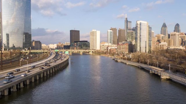 Modern metropolis with skyscrapers on the banks of a river, Philadelphia waterfront, aerial hyper-lapse, timelapse