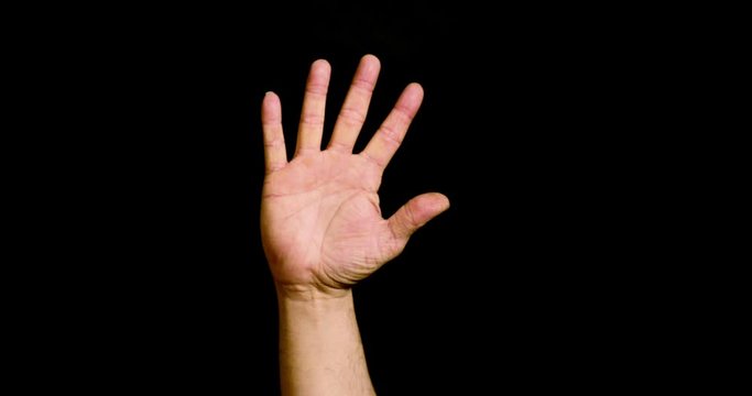 Male hand showing the number five on black background