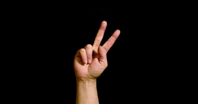 Male hand counting from number one to five on black background